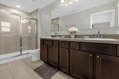 a bathroom with a sink and a toilet and a shower at 4732TH Cozy home in Kissimmee in Kissimmee