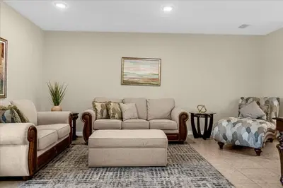 a living room with a couch and a chair at 3BD townhome near Disney 4730 in Kissimmee
