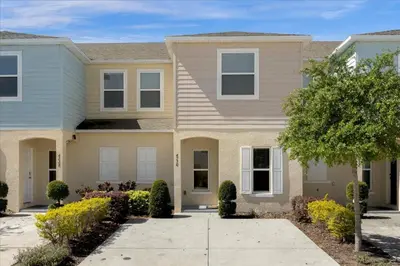 a house in a neighborhood with a driveway at 3BD townhome near Disney 4730 in Kissimmee