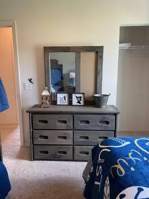 a dresser with a mirror in a bedroom at Disney Dream Resort Amenities Pool *4BD/3BA* Close to Parks in Kissimmee