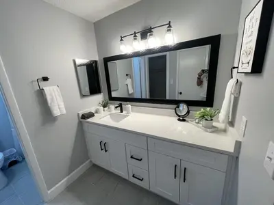 a bathroom with a white sink and a mirror at Family-Friendly DIsney Getaway in Kissimmee
