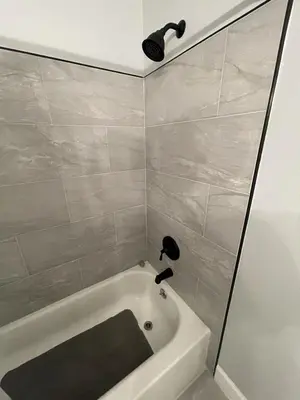 a bathroom with a bath tub and a shower at Family-Friendly DIsney Getaway in Kissimmee