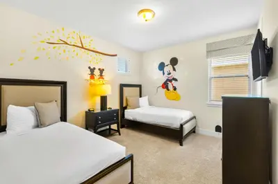 a bedroom with two beds and a mickey mouse mural at Delightful Home Near Disney With Private Pool, Themed & Game Room With Waterpark & Resort Access At Encore Resorts Reunion - 451No in Kissimmee