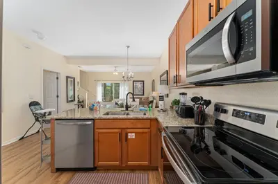 a kitchen with a sink and a stove top oven at Pool Townhouse near to Disney - Bella Vida Resort in Kissimmee