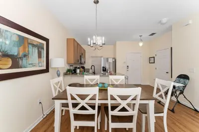 a dining room and kitchen with a table and chairs at Pool Townhouse near to Disney - Bella Vida Resort in Kissimmee