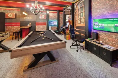 a ping pong table in a room with a billiard at Modern 5 BDR Family Themed Home with Harry Potter Games Room and Free Pool Heat in Orlando