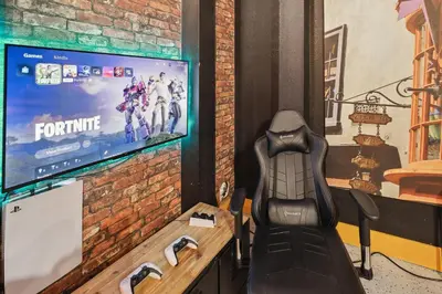 a batman chair in front of a television at Modern 5 BDR Family Themed Home with Harry Potter Games Room and Free Pool Heat in Orlando