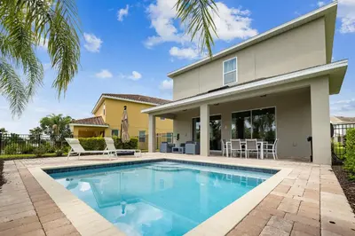 a swimming pool in front of a house at Modern 5 BDR Family Themed Home with Harry Potter Games Room and Free Pool Heat in Orlando