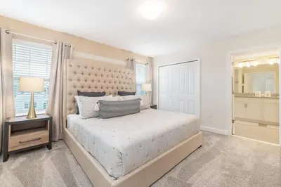 a bedroom with a large bed and a mirror at Magic villa with themed bedrooms and private pool in Kissimmee