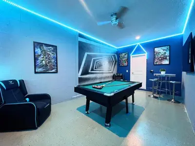 a blue room with a pool table and a couch at 5 Bed 5 Bath South Facing Pool Home Storey Lake home in Kissimmee