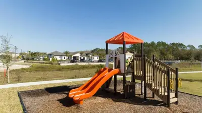 a playground with an orange slide and an umbrella at Gorgeous 4 Bedroom w Screened Pool Close to Disney 2653 in Kissimmee
