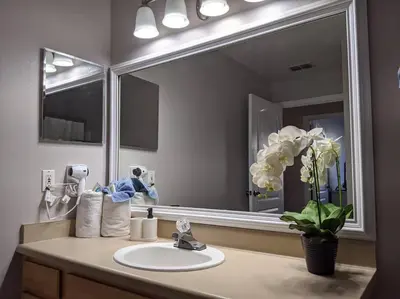 a bathroom with a sink and a large mirror at Nice & Cozy - Vacation Home in Kissimmee