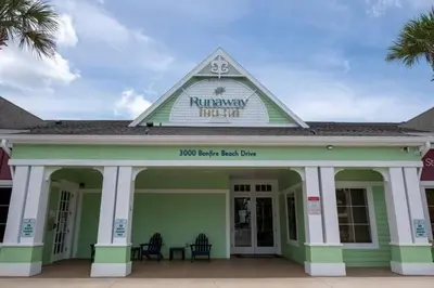 a green building with a sign on top of it at Nice & Cozy - Vacation Home in Kissimmee
