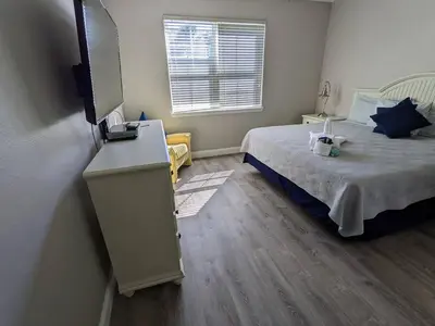a bedroom with a bed and a television in it at Nice & Cozy - Vacation Home in Kissimmee
