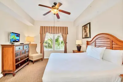 a bedroom with a bed and a ceiling fan at 2BR Resort Suite - Fountain View Private Balcony in Kissimmee