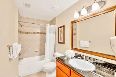 a bathroom with a sink and a tub and a toilet at 2BR Resort Suite - Fountain View Private Balcony in Kissimmee