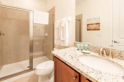 a bathroom with a sink and a toilet and a shower at Fantabulous Disney Vacation House in Orlando