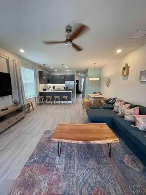 a living room with a blue couch and a table at Like home, but better in Orlando
