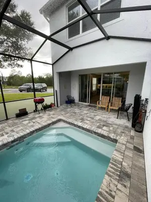 a swimming pool in the backyard of a house at Like home, but better in Orlando
