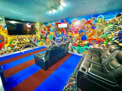 a room with a painting on the wall at The Marvel Mansion 5BR Pool Home Near Disney World in Orlando