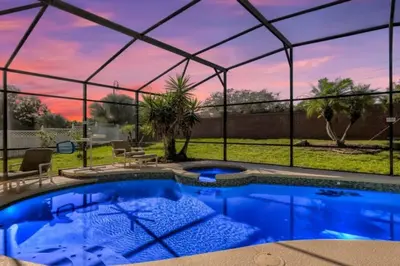 a large swimming pool with a pergola and a patio at The Marvel Mansion 5BR Pool Home Near Disney World in Orlando