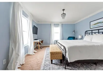 a blue bedroom with a bed and a desk at Lakefront 5BR Resort Pool Home Near Disney World in Kissimmee