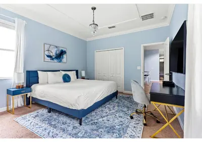 a blue bedroom with a bed and a desk at Lakefront 5BR Resort Pool Home Near Disney World in Kissimmee