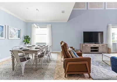 a dining room and living room with a table and chairs at Lakefront 5BR Resort Pool Home Near Disney World in Kissimmee