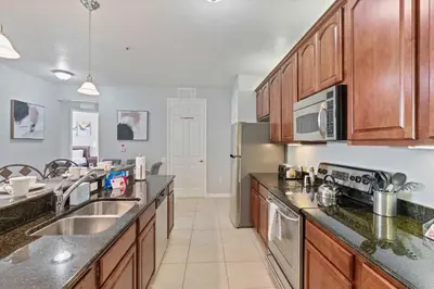 a kitchen with stainless steel appliances and wooden cabinets at 4804 Cayview Avenue 305 in Orlando