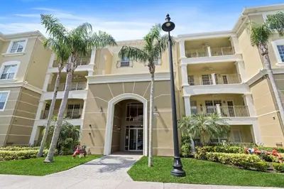 a building with palm trees in front of it at 4804 Cayview Avenue 305 in Orlando