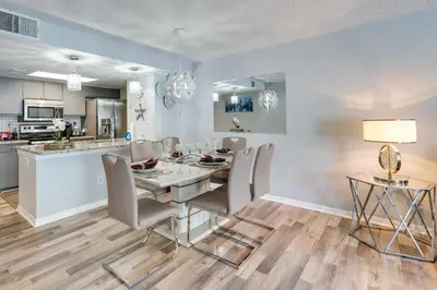 a kitchen and dining room with a table and chairs at Kissimmee Vacation Rental - 5 Mi to Disney World! in Kissimmee