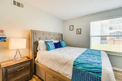 a bedroom with a bed and a lamp and a window at Kissimmee Vacation Rental - 5 Mi to Disney World! in Kissimmee