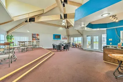 a large room with tables and chairs and blue walls at Kissimmee Vacation Rental - 5 Mi to Disney World! in Kissimmee