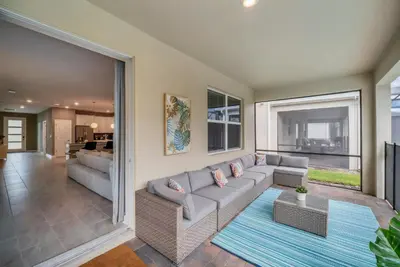 a living room with a couch and a table at 9 Bedrooms 5 Bathrooms Storey Lake 2854 Bd in Kissimmee