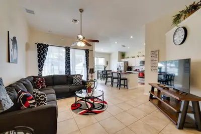 a living room with a couch and a table at Kissimmee Vacation Rental with Pool about 4 Mi to Disney in Kissimmee