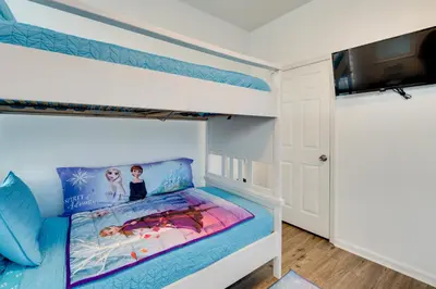 a bedroom with a bunk bed with a blue and white at Kissimmee Vacation Rental with Pool about 4 Mi to Disney in Kissimmee