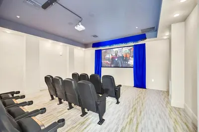 a waiting room with black chairs and a projection screen at Near Disney - 3BR Condo - Pool and Games in Orlando