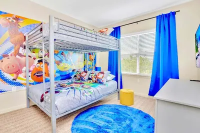 a bedroom with a bunk bed with a disney characters mural at 3BR Condo - Pool Sauna - Near Disney in Orlando