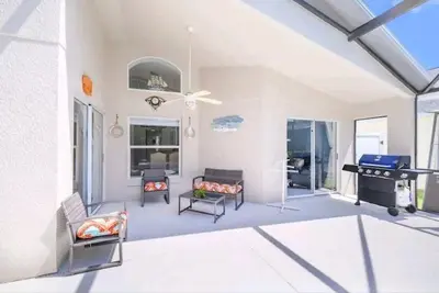 a living room with a fireplace and a stove at Relaxing, Private Family Home At Lake Berkley Resort, South Facing Pool, Near Disney, SeaWorld in Kissimmee