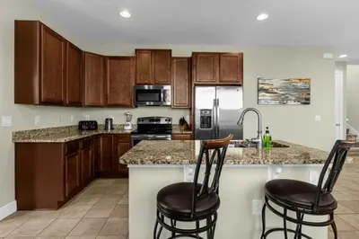 a kitchen with wooden cabinets and a counter top at Multiple Family Homes - 23 Rooms PoolsSpas in Orlando
