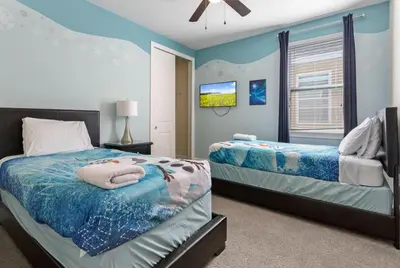 a bedroom with two beds and a tv in it at Multiple Family Homes - 23 Rooms PoolsSpas in Orlando