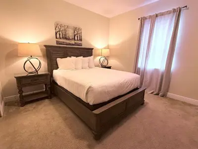 a bedroom with a bed and two lamps and a window at Multiple Family Homes - 23 Rooms PoolsSpas in Orlando