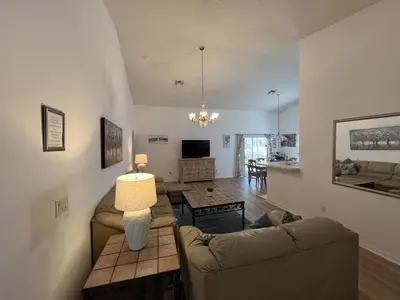 a living room with two couches and a table at Rise & Shine! in Orlando