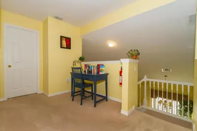 a childs room with yellow walls and a table with books at Home With A View! in Orlando