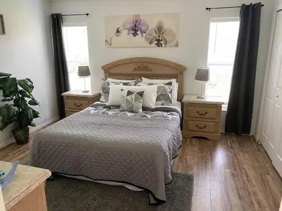 a bedroom with a large bed and two night stands at Just Wanna Have Sun! in Orlando