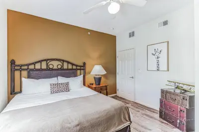 a bedroom with a large bed and a ceiling fan at Pirate Ship Resort Condo in Orlando