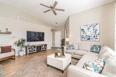 a living room with a couch and a ceiling fan at THIS IS PARADISE FOUND! Private In-Ground Pool Home, Views, Near Dis, NO Steps, LOW Rates! in Kissimmee