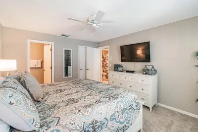 a bedroom with a bed and a flat screen tv at THIS IS PARADISE FOUND! Private In-Ground Pool Home, Views, Near Dis, NO Steps, LOW Rates! in Kissimmee