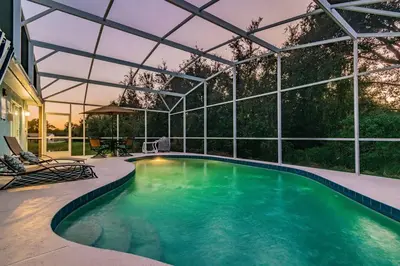 an indoor swimming pool with a pergola at THIS IS PARADISE FOUND! Private In-Ground Pool Home, Views, Near Dis, NO Steps, LOW Rates! in Kissimmee