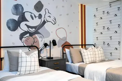 a bedroom with two beds and a mural of a monkey at Brand new fantastic home at Storey lake (SL4447) in Kissimmee